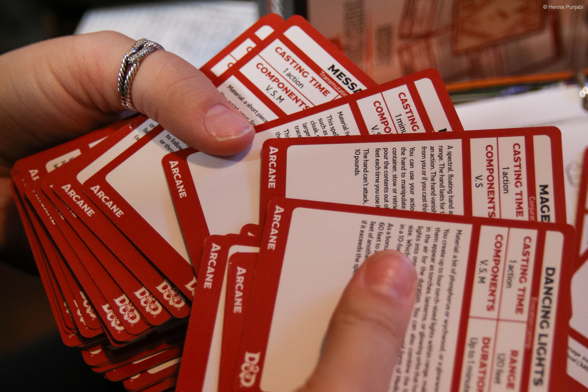 person fanning out a set of arcane spell cards